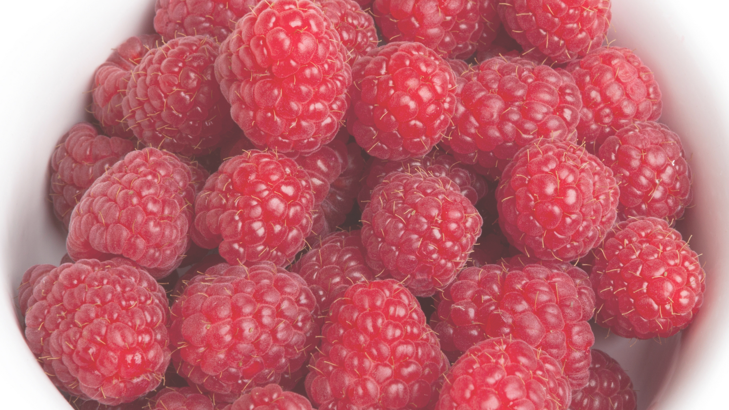 A vibrant hair mask adorned with ripe raspberries, representing the fusion of hair care and nature's goodness for healthier, luscious locks."